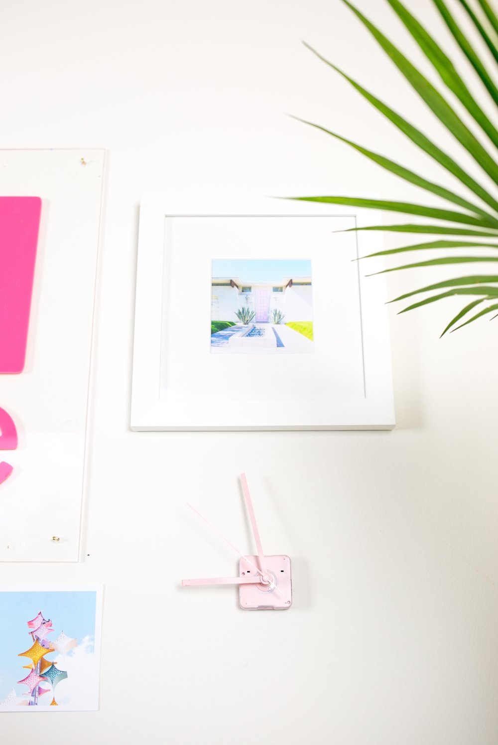  A Framebridge framed print of that pink door and a quirky spray painted clock 