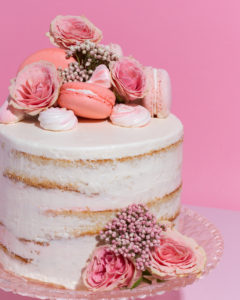 cake with macaroons and flowers on top lish creative