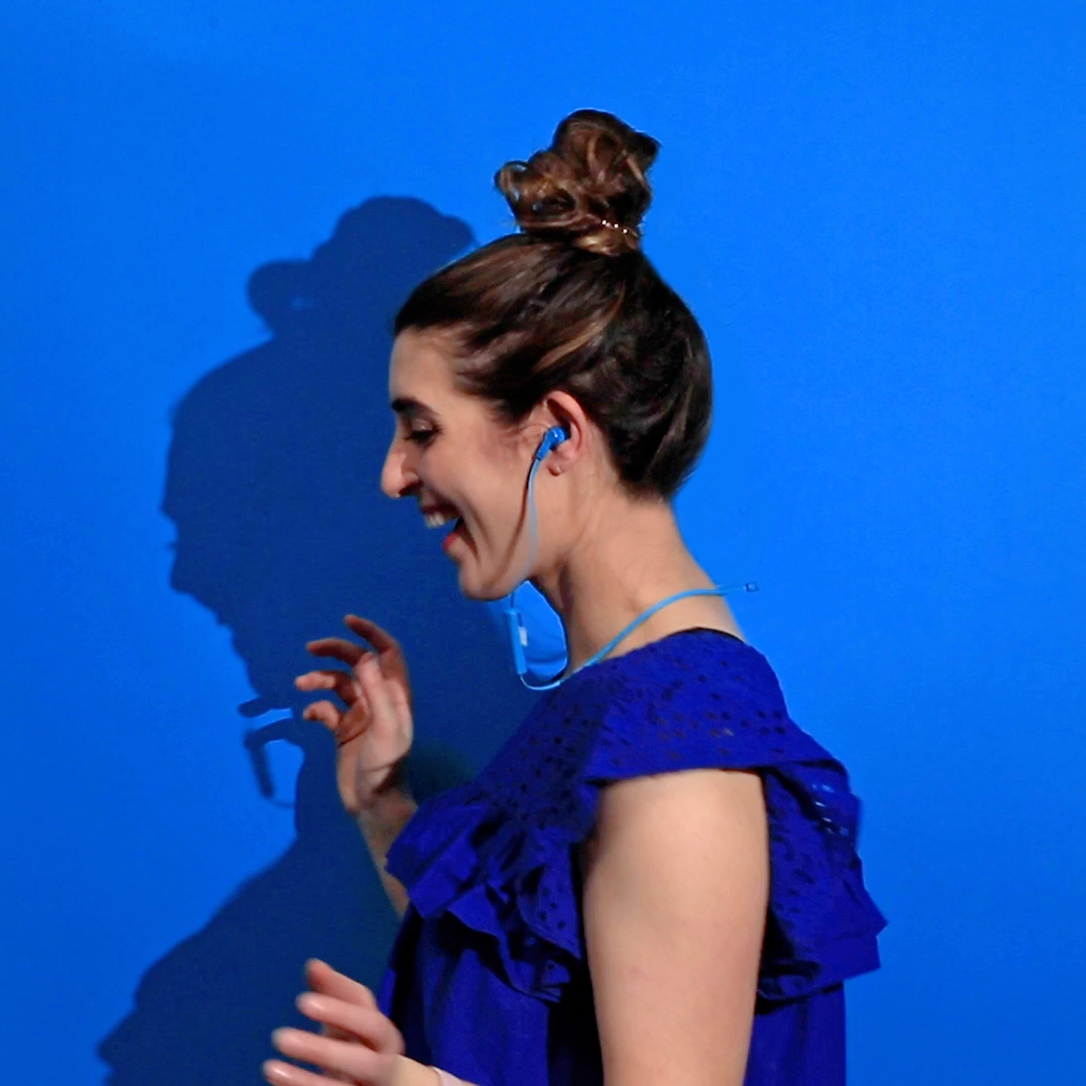 Woman wearing Sharper image blue headphones
