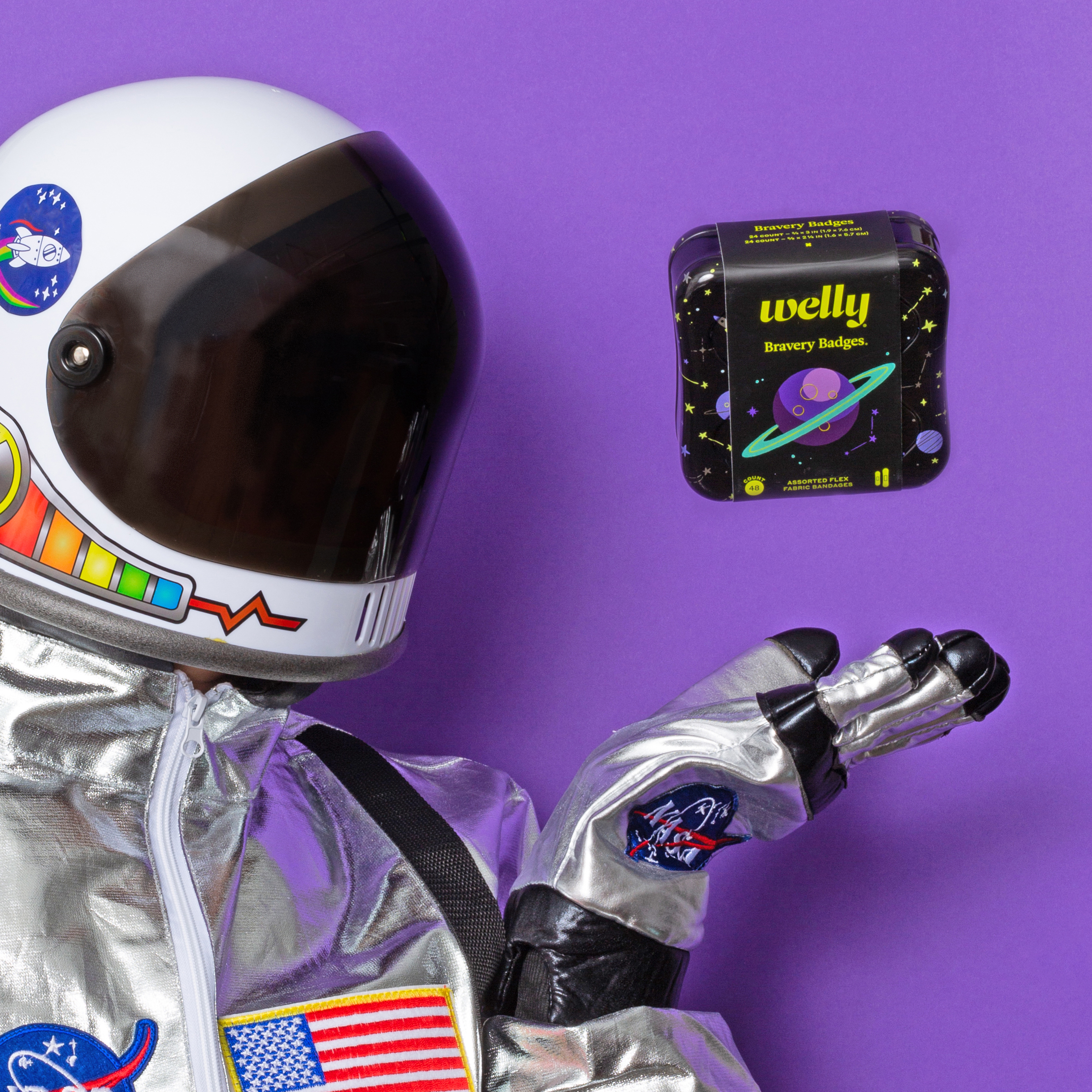 astronaut reaching for space-themed tin of welly bravery bandages