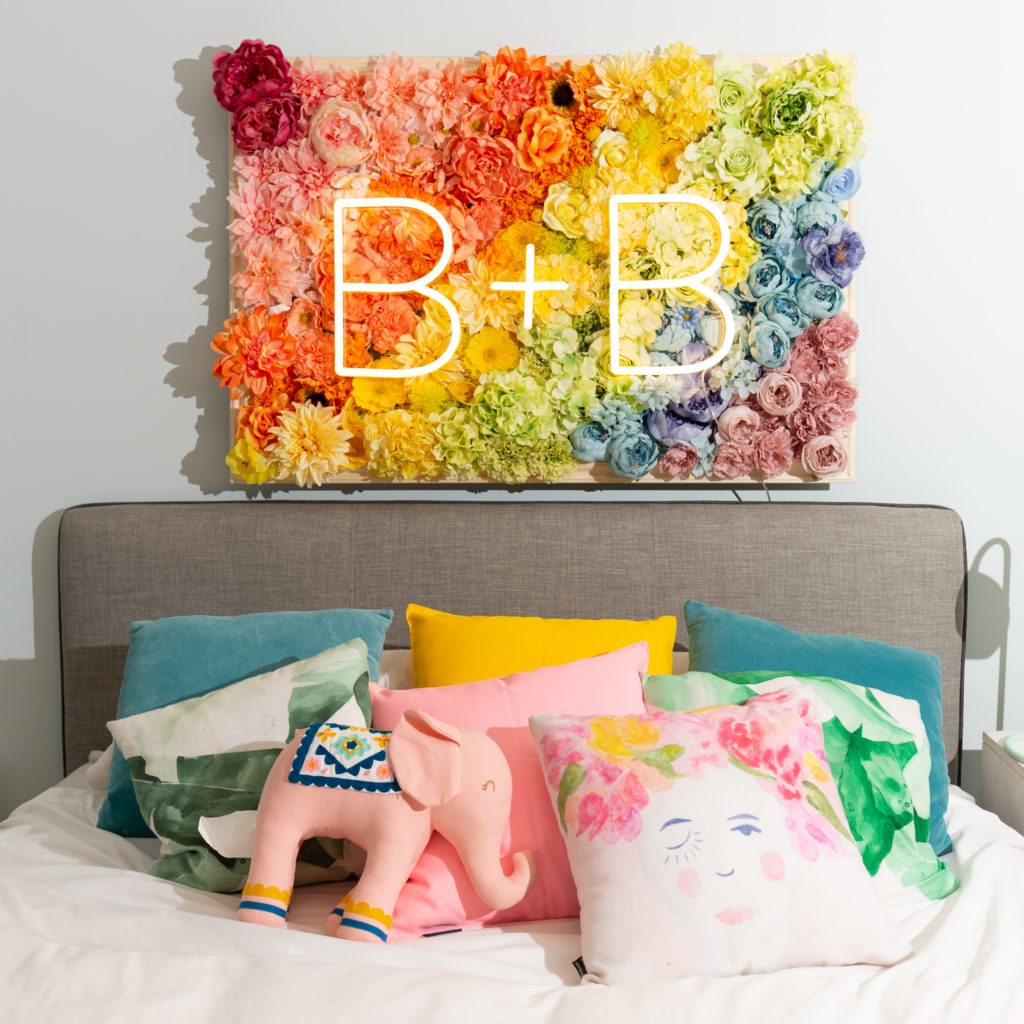 Brite Lite with floral backdrop over bed