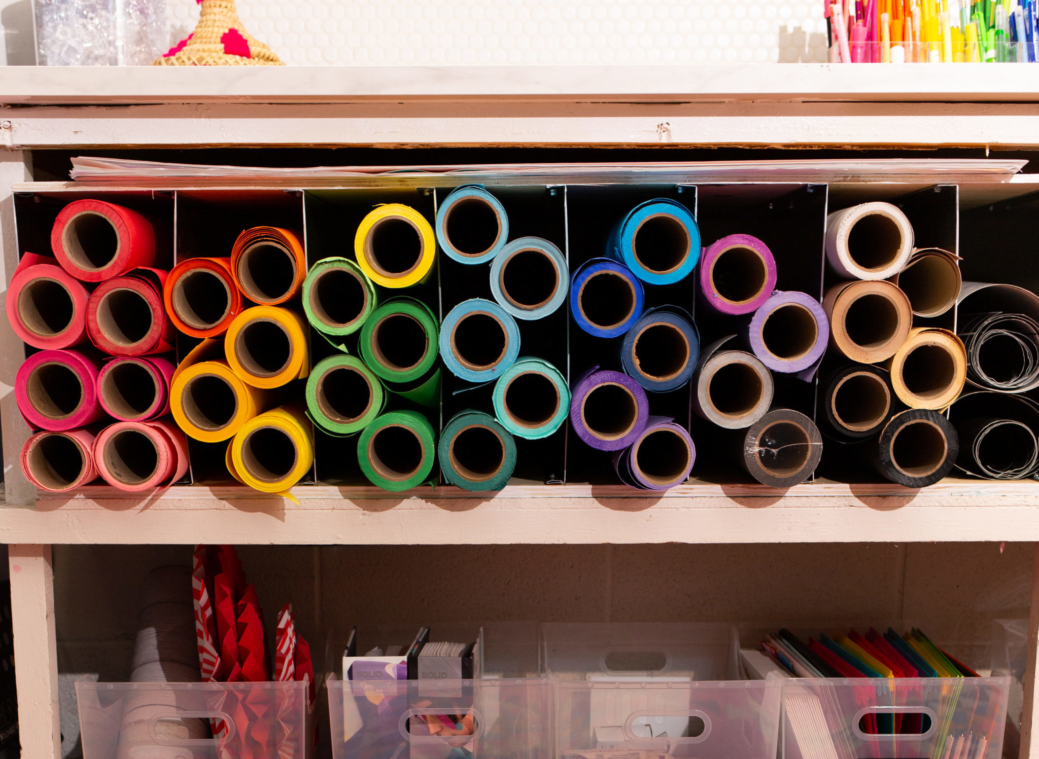 rolls of seamless paper organized neatly in rainbow order