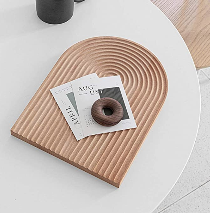 arched, textured serve board on table