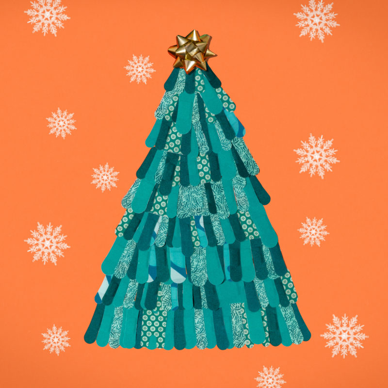 WELLY BANDAGES GREEN CHRISTMAS TREE ON ORANGE BACKGROUND WITH SNOWFLAKES