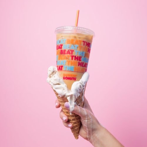 ice cream cone in hand with Dunkin' iced coffee displayed inside cone