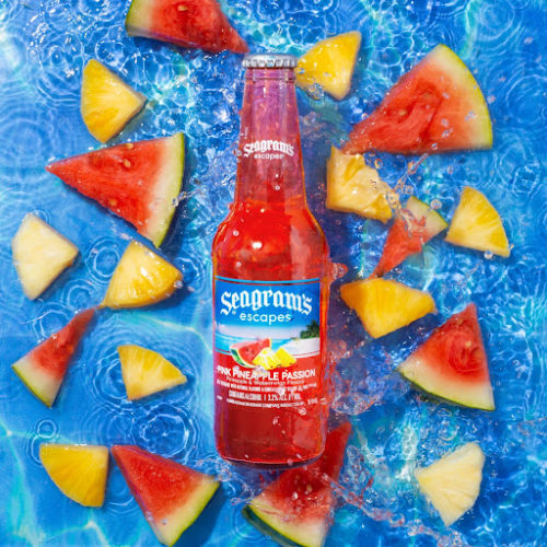 seagram's beverage displayed in water surrounded by fruit