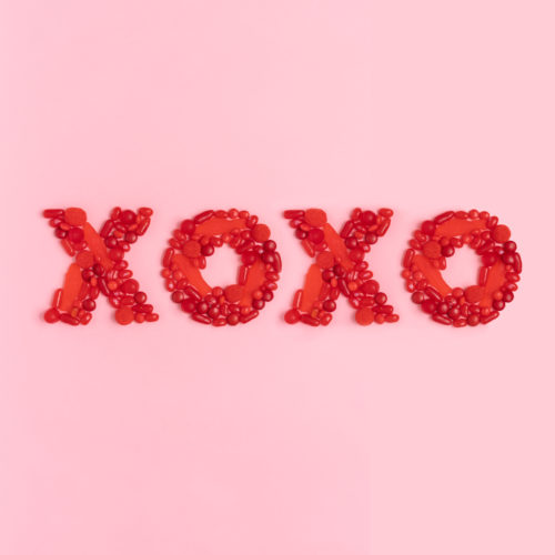 red letters xoxo displayed and made out of red candy
