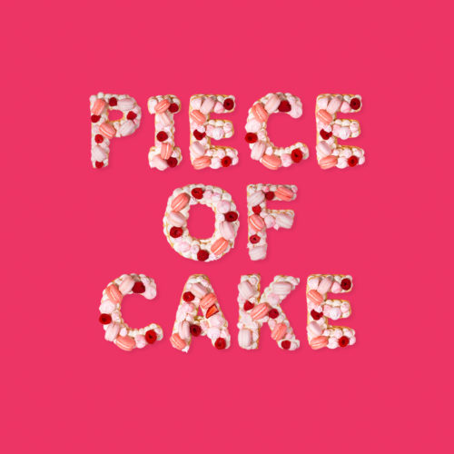 the phrase “piece of cake” displayed made out of cake and dessert